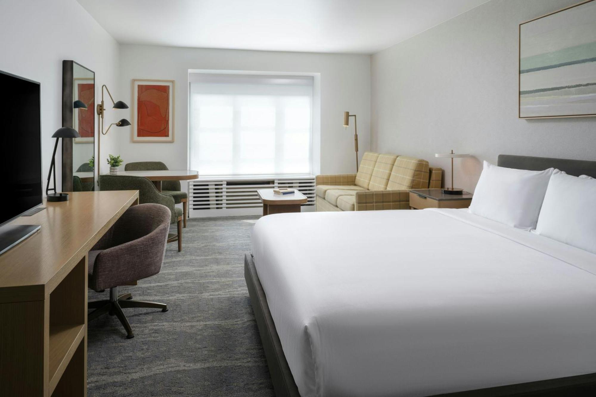 Größeres Zimmer mit Kingsize-Bett und Stadtblick